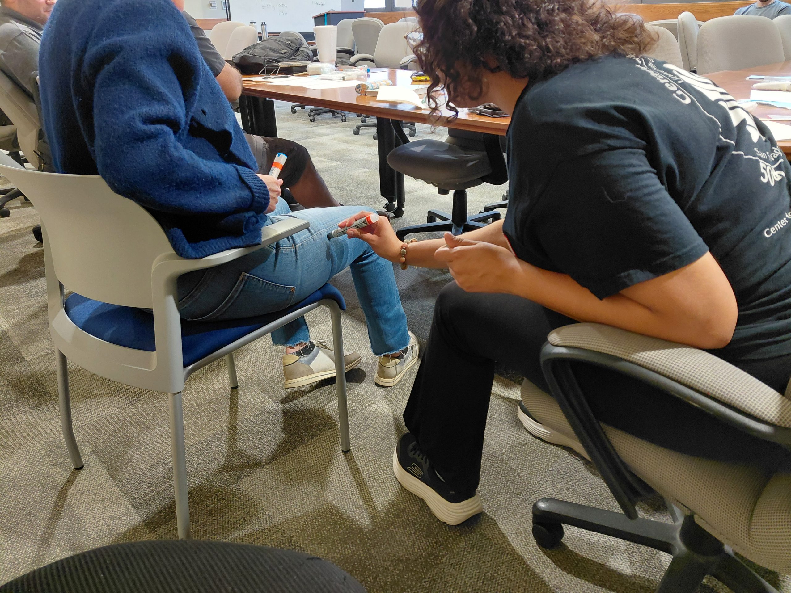 A student practices EpiPen administration technique on another student during<br />
the Expedition School Wilderness First Aid training session at UT Austin.